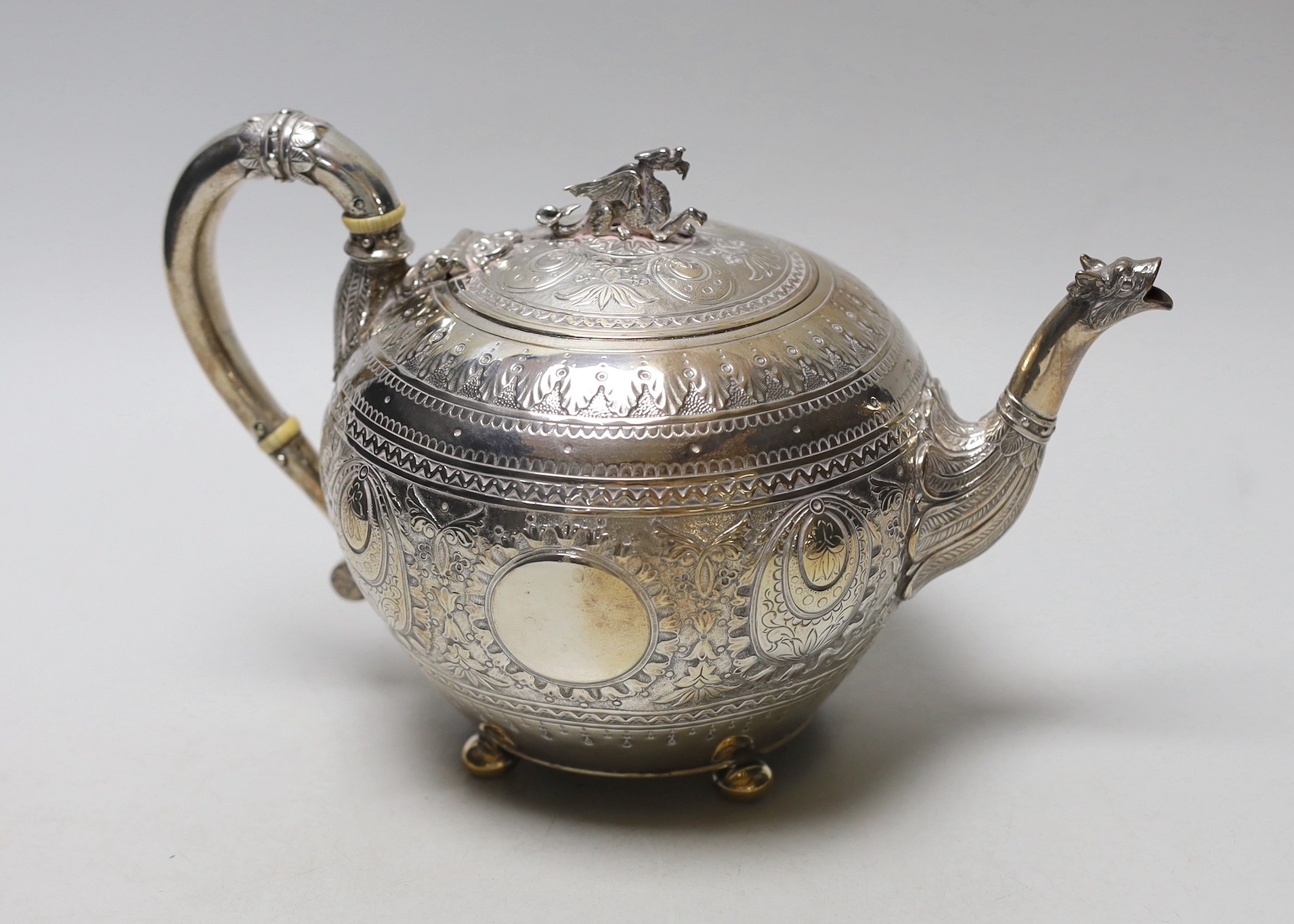 A Victorian embossed silver globular teapot, by William & John Barnard, London, 1893, with dragon finial and mask spout, gross weight 22.1oz.